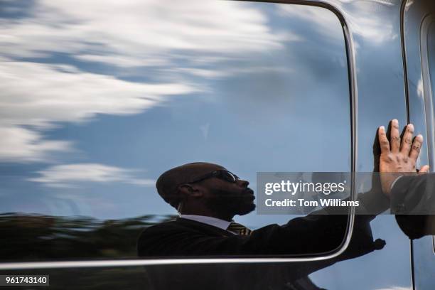 Member of the security detail for Senate Minority Leader Charles Schumer, D-N.Y., prepares to let him out of an SUV at the Exxon gas station at...