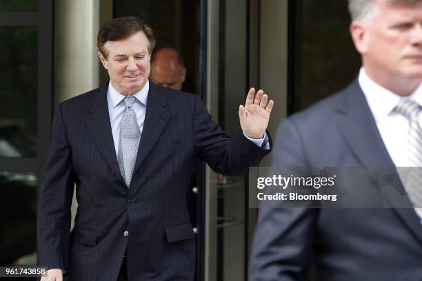 Paul Manafort, former campaign manager for Donald Trump, waves while exiting federal court in Washington, D.C., U.S., on Wednesday, May 23, 2018....