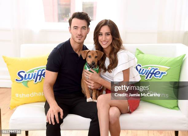 Kevin Jonas and Danielle Jonas pose with an adoptable puppy to promote Pet Adoption During National Pet Month at Home Studios on May 23, 2018 in New...