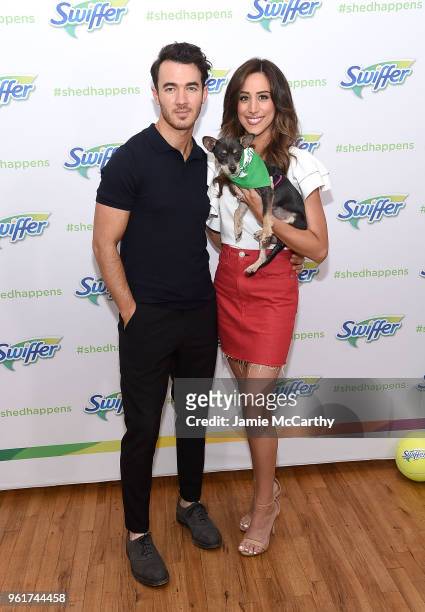 Kevin Jonas and Danielle Jonas pose with an adoptable puppy to promote Pet Adoption During National Pet Month at Home Studios on May 23, 2018 in New...