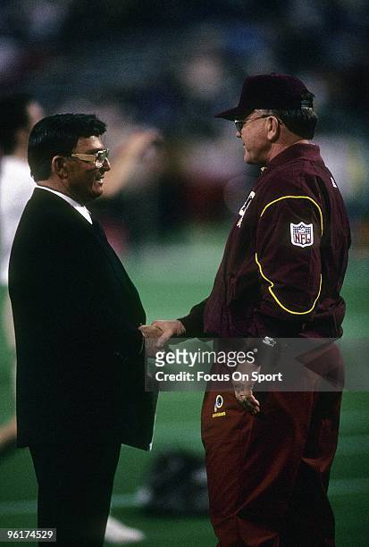 Joe Gibbs head coach of the Washington Redskins shakes hands with former head coach of the Kansas City Chiefs Hank Stram on the field before a mid...