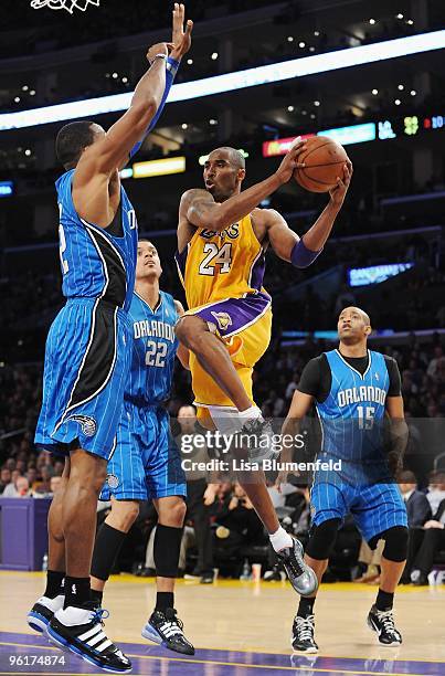 Kobe Bryant of the Los Angeles Lakers drives to the basket against Dwight Howard of the Orlando Magic at Staples Center on January 18, 2010 in Los...