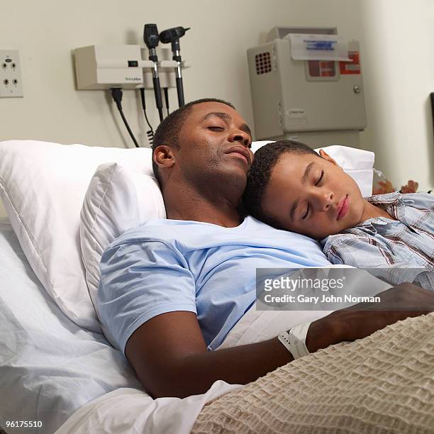 son sleeps with father in hospial bed - gary bond stock pictures, royalty-free photos & images