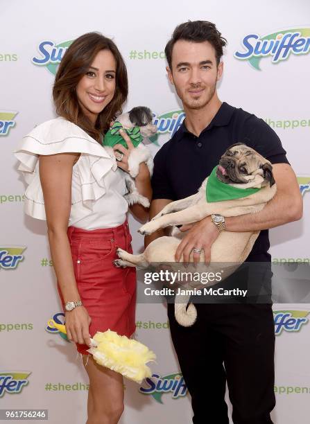 Danielle Jonas and Kevin Jonas pose with Tinkerbelle the Dog and Doug the Pug to Pet Adoption During National Pet Month at Home Studios on May 23,...