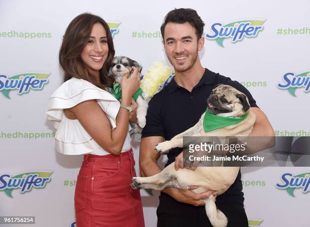 Danielle Jonas and Kevin Jonas pose with Tinkerbelle the Dog and Doug the Pug to Pet Adoption During National Pet Month at Home Studios on May 23,...