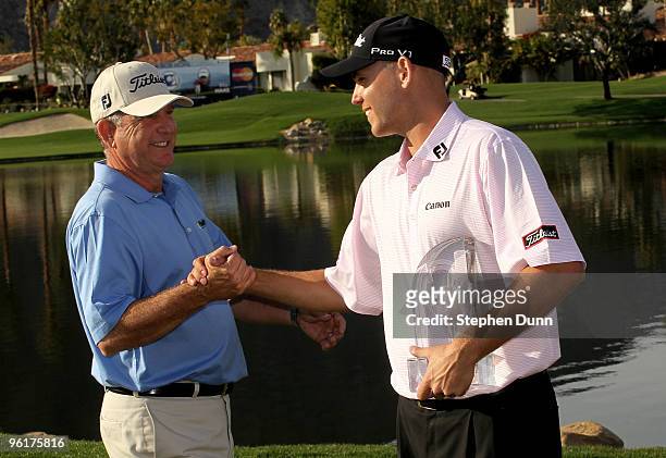 Bill Haas is congratulated by father and former tournament champion Jay Haas on the 18th green after Bill's victory at the Palmer Private course at...