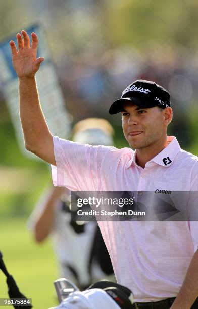 Bill Haas waves as he heads to the scorer's tent after winning at the Palmer Private course at PGA West during the final round of the Bob Hope...