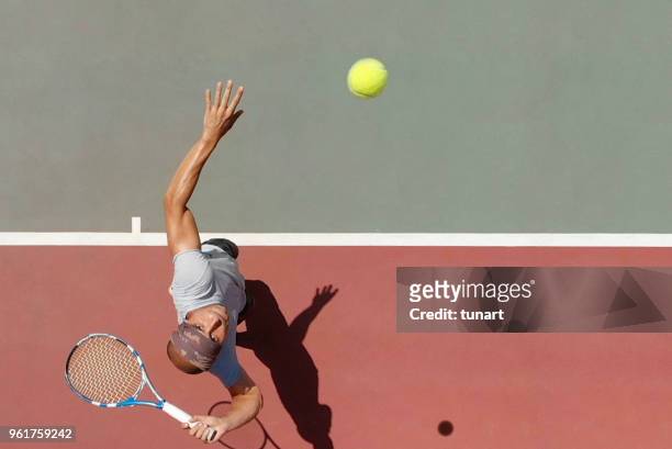 tennis player serving - taking a shot sport stock pictures, royalty-free photos & images