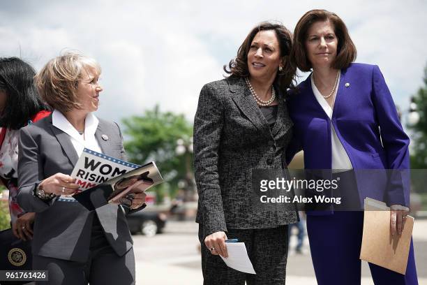 Sen. Kamala Harris shares a moment with Sen. Catherine Cortez Masto as Rep. Michelle Lujan Grisham looks on during a news conference on immigration...