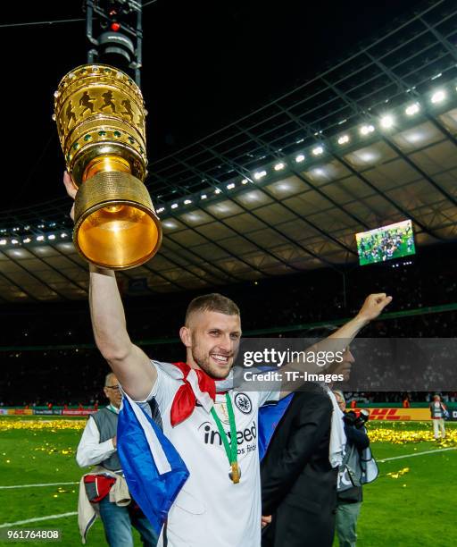 Ante Rebic of Frankfurt celebrates with the trophy after winning the DFB Cup final between Bayern Muenchen and Eintracht Frankfurt at Olympiastadion...