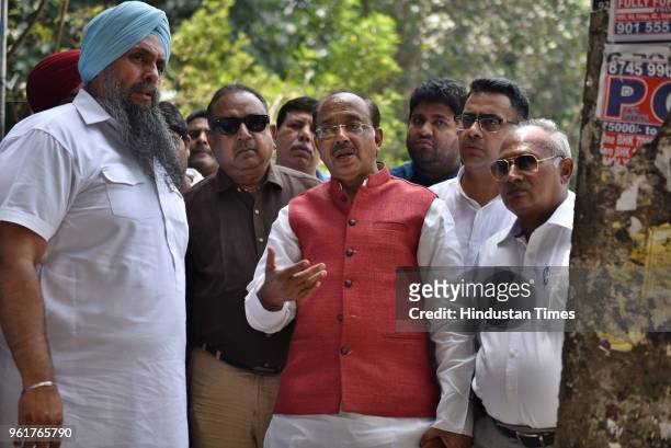 Union Minister Vijay Goel speaks to the residents of Rajendra Nagar whose structures got demolished by Municipal Corporation of Delhi during...