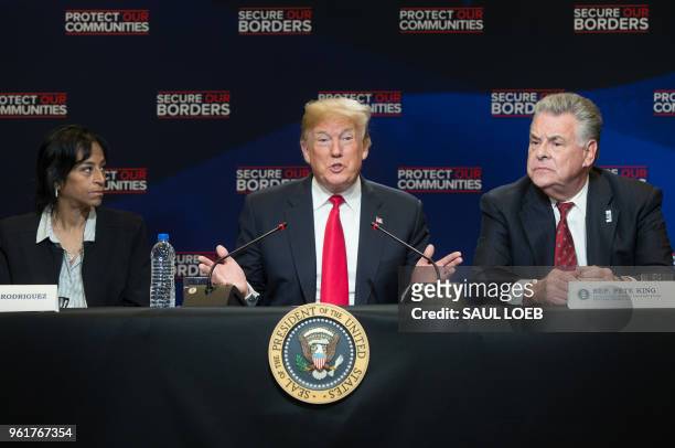 President Donald Trump speaks alongside US Representative Peter King , Republican of New York, and Evelyn Rodriguez , whose daughter was killed by...