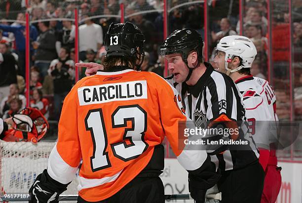Dan Carcillo of the Philadelphia Flyers is separated from Matt Cullen of the Carolina Hurricanes by Referee Kevin Pollock on January 23, 2010 at the...