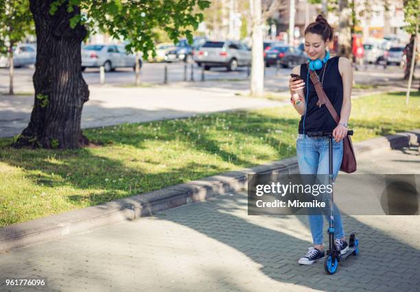 young woman texting on her phone in the city center - 2017 common good forum stock pictures, royalty-free photos & images