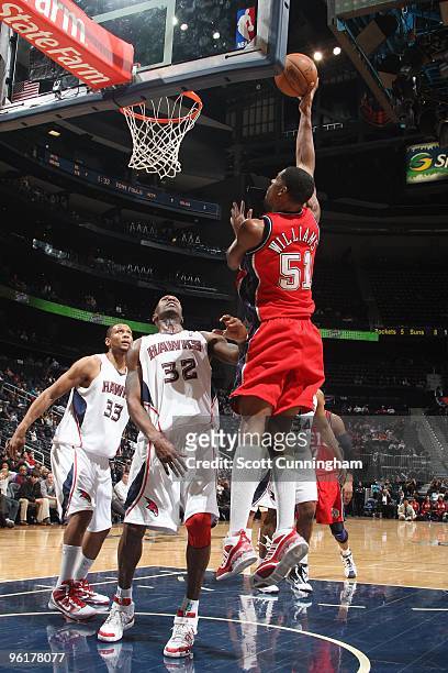 Sean Williams of the New Jersey Nets lays up a shot against Joe Smith of the Atlanta Hawks during the game on January 6, 2010 at Philips Arena in...