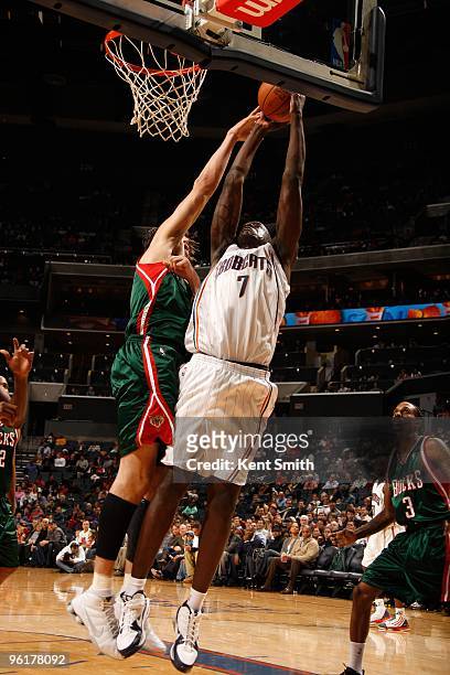 DeSagana Diop of the Charlotte Bobcats looks to score against Andrew Bogut of the Milwaukee Bucks during the game on December 28, 2009 at the Time...