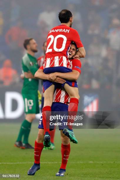 Juanfran of Atletico Madrid celebrates with teammate Koke after winning the UEFA Europa League Final between Olympique de Marseille and Club Atletico...