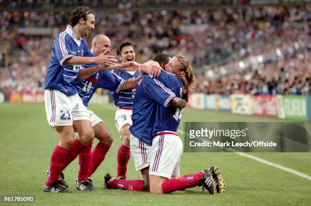 July 1998 FIFA World Cup Final - France v Brazil - Emmanuel Petit celebrates on his knees after scoring the third goal for France and is embraced by...
