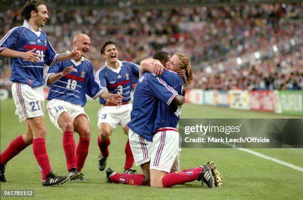 July 1998 FIFA World Cup Final - France v Brazil - Emmanuel Petit celebrates on his knees after scoring the third goal for France and is embraced by...