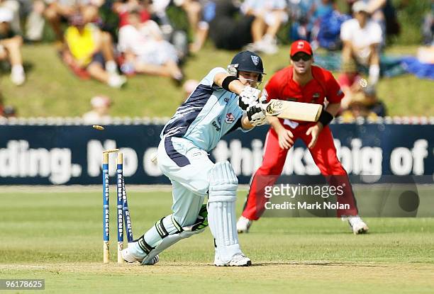 Phillip Hughes of the Blues is bowled by Gary Putland of the Redbacks during the Ford Ranger Cup match between the Blues and the Redbacks at North...