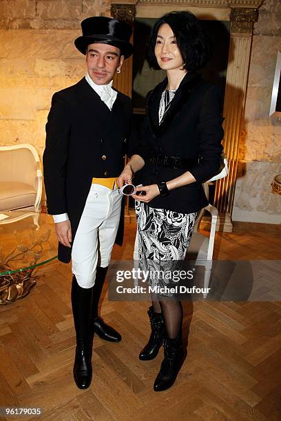 John Galliano and Maggie Cheung attend the Christian Dior Haute-Couture show as part of the Paris Fashion Week Spring/Summer 2010 at Boutique Dior on...