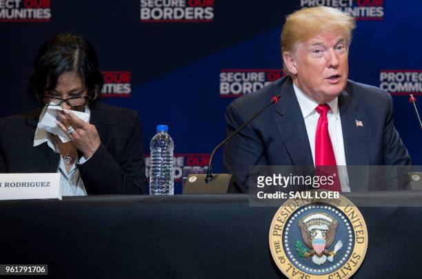President Donald Trump speaks alongside Evelyn Rodriguez , whose daughter was killed by MS-13 gang members, during a roundtable discussion on...