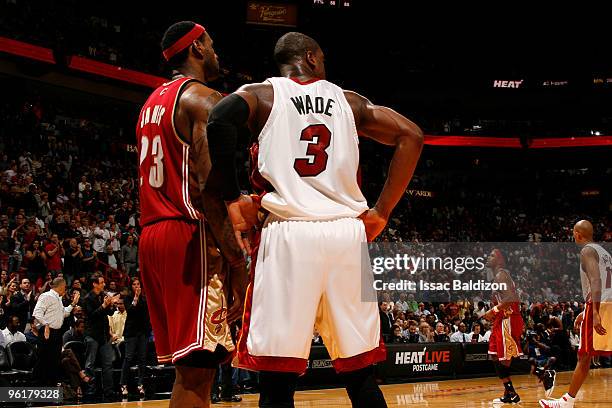 Dwyane Wade of the Miami Heat and LeBron James of the Cleveland Cavaliers take a breather on January 25, 2010 at American Airlines Arena in Miami,...