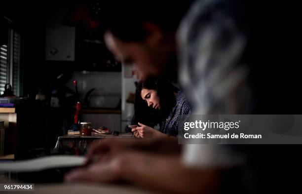 Esteban Ernesto Montedonico and Laura Barroso Huber work the leather in his workshop. 'Cuero y Alma' Handicraft Made in Spain on April 26, 2018 in...