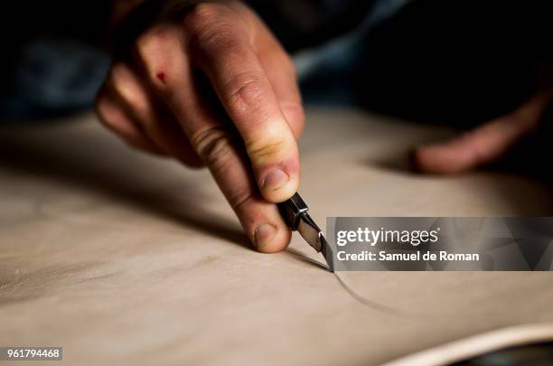 Esteban Ernesto Montedonico works the leather in his workshop. 'Cuero y Alma' Handicraft Made in Spain on April 26, 2018 in Madrid, Spain.