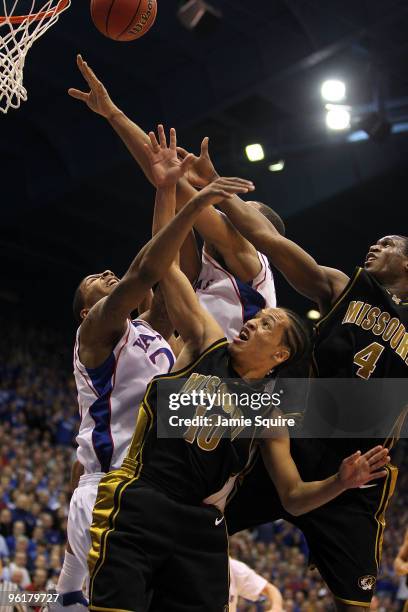 Michael Dixon of the Missouri Tigers reaches for a rebound during the game against the Kansas Jayhawks on January 25, 2010 at Allen Fieldhouse in...