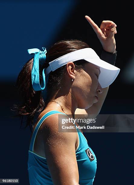 Jie Zheng of China refers a line call in her quarterfinal match against Maria Kirilenko of Russia during day nine of the 2010 Australian Open at...