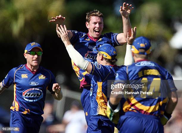 Ian Butler of Otago celebrates the wicket of Gareth Hopkins of Auckland during the HRV Cup Twenty20 match between the Auckland Aces and the Otago...