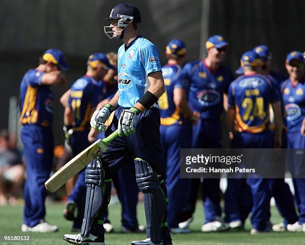 Martin Guptill of Auckland walks off after being dismissed by Warren McSkimming of Otago during the HRV Cup Twenty20 match between the Auckland Aces...