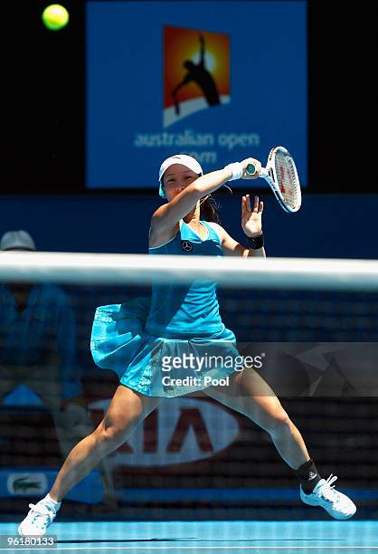 Jie Zheng of China plays a forehand in her quarterfinal match against Maria Kirilenko of Russia during day nine of the 2010 Australian Open at...
