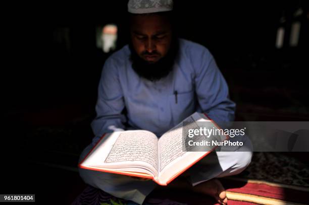 Nepalese Muslim reading Quran a holy book during the Ramadan celebrated in Nepali Jame mosque, Kathmandu, Nepal on Wednesday May 23, 2018. Ramadan is...
