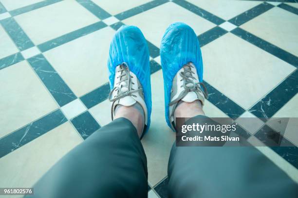 man with shoe protector - protective footwear stock pictures, royalty-free photos & images