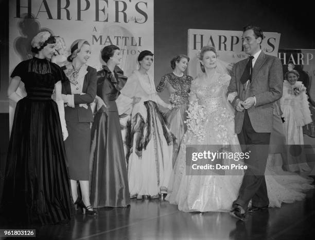 English actors Anna Neagle and Michael Wilding filming 'Maytime in Mayfair' at the Borehamwood studios in Hertfordshire, 2nd March 1949. All the...