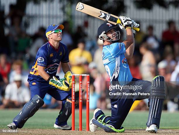 Colin de Grandhomme of Auckland smashes the ball away for six runs during the HRV Cup Twenty20 match between the Auckland Aces and the Otago Volts at...