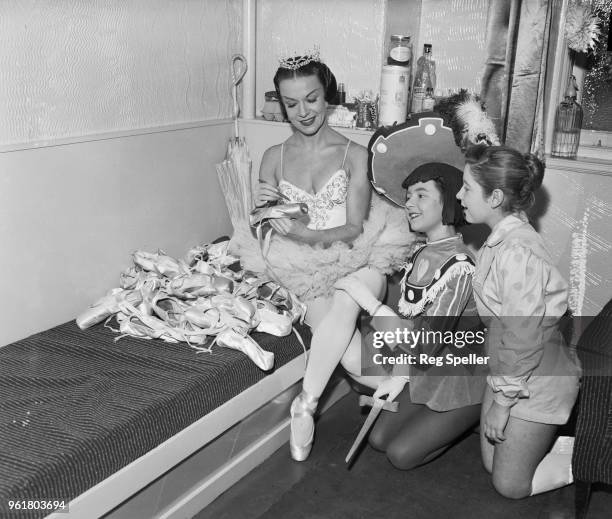 Ballerina Marina Svetlova autographs her old ballet shoes for Tawya Trude and Jill Carter from the Aida Foster Theatre School, backstage at the...