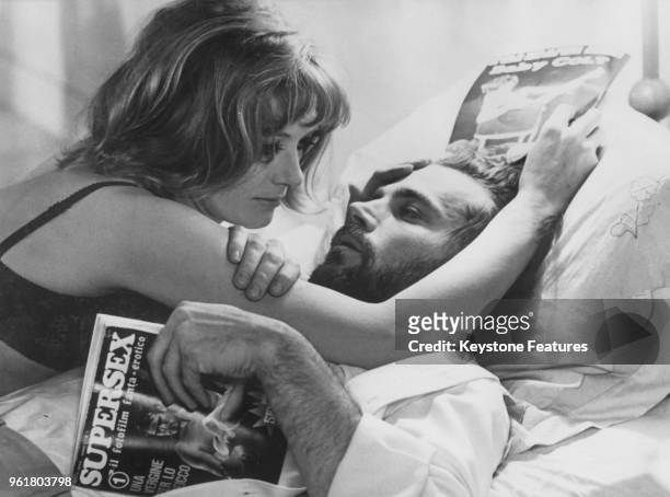 Actors Franco Nero and Vanessa Redgrave star in the film 'A Quiet Place in the Country', directed by Elio Petri, May 1968. Nero is reading a copy of...