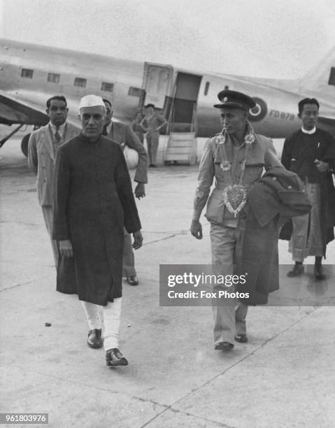 Jawaharlal Nehru , Vice President of the Executive Council of India, and Aung San , Premier of Burma, leave the airport in Delhi, January 1947. Aung...