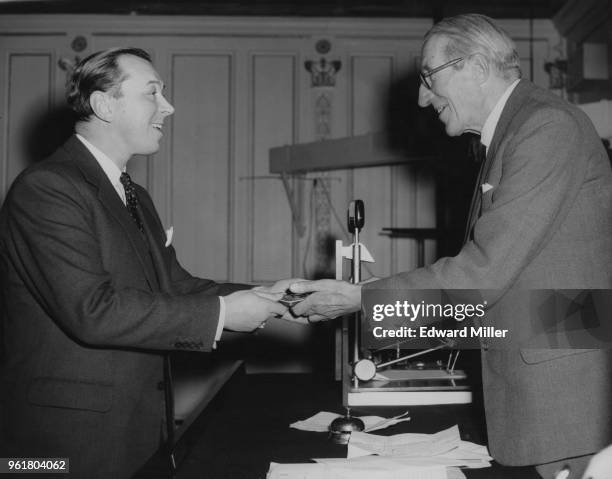 Henry George Nelson , managing director of the English Electric Company, receives the Benjamin Franklin medal from Oswald P. Milne , chairman of the...