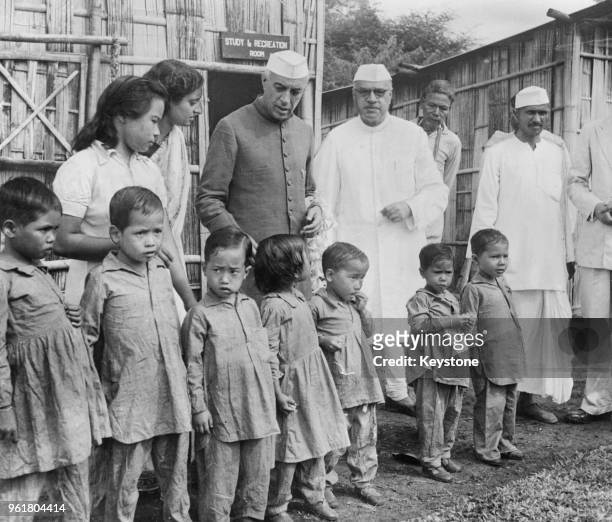 Jawaharlal Nehru , Prime Minister of India, visits children at the leper colony at Pasighat, Assam, with Jairamdas Daulatram , Governor of Assam ,...