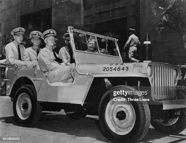Admiral Chester William Nimitz , the Commander-in-Chief of the US Pacific Fleet, takes a ride around Pearl Harbor in Hawaii with his aides-de-camp,...