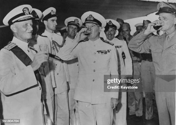 Admiral Chester William Nimitz , the Commander-in-Chief of the Allied forces in the Pacific during World War II, drinks a toast after receiving the...
