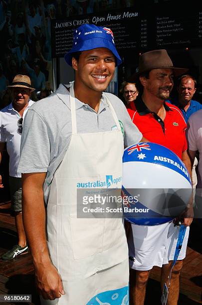 Jo-Wilfried Tsonga and Henri Leconte of France enjoy a barbecue on Australia Day during day nine of the 2010 Australian Open at Melbourne Park on...