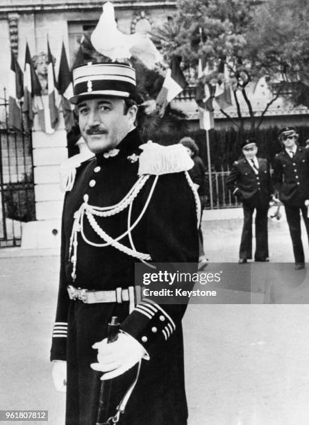 English actor Peter Sellers provides an unexpected perch for a dove, whilst filming a scene for 'Revenge of the Pink Panther' in the south of France,...