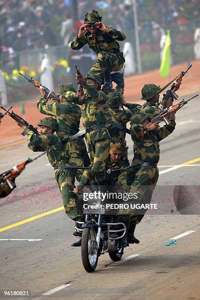 Indian Border Security Force soldiers perform motorcycle stunts during the Indian Republic Day parade in New Delhi on January 26, 2010. Blanket fog...