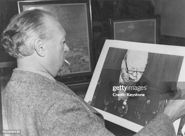 English painter Ruskin Spear, RA with a photograph of his painting of Winston Churchill, which will be shown at the Royal Academy's Summer...