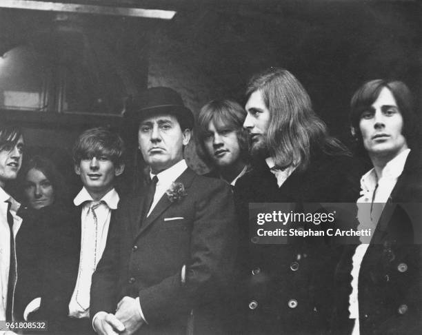 Italian actor and director Alberto Sordi poses with a group of extras from Eel Pie Island during the filming of 'Fumo di Londra' in London, 1966....